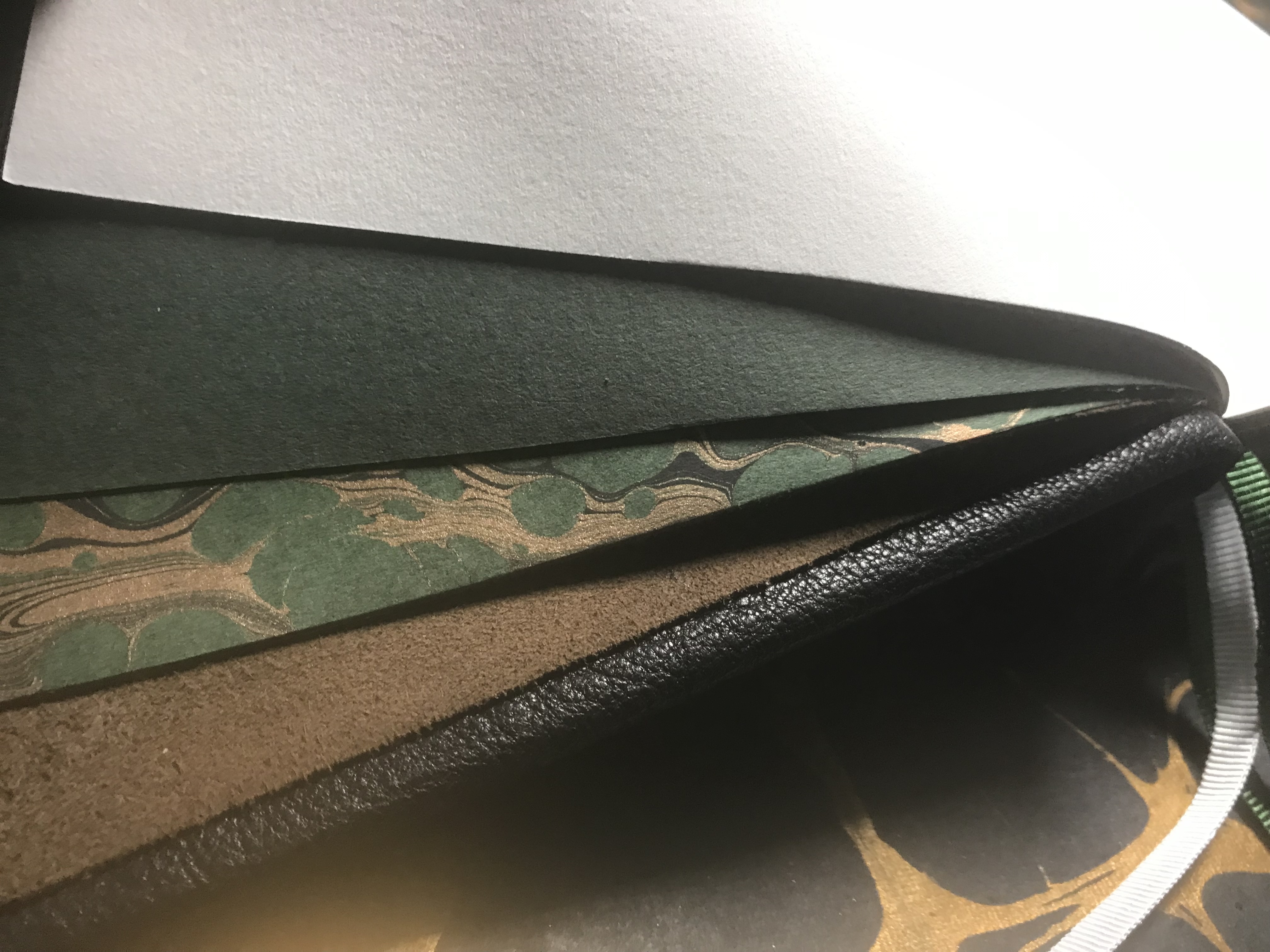 Hard crafted leather bound hardback book with suede, marbling and different textures and sensations
